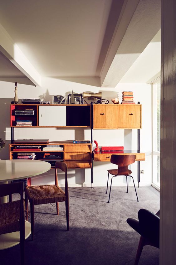 a mid-century modern unit with drawers, closed and open storage unit with a desk in the lower part