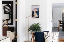 a navy chair with a stained frame, armrests and legs and a printed pillow will add mid-century modern chic to the space