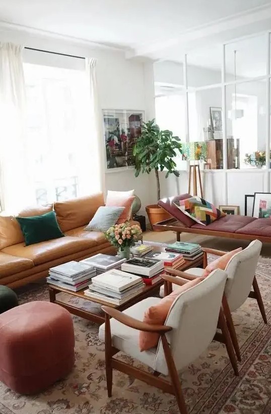 a neutral living room done with warm-colored furniture, with pretty pillows, artworks and potted plants