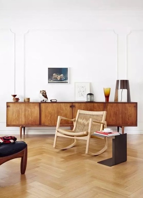 a rich-stained mid-century modern sideboard with doors and cutout handles is a classic solution that suits many spaces