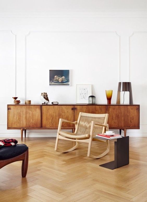 a rich-stained mid-century modern sideboard with doors and cutout handles is a classic solution that suits many spaces