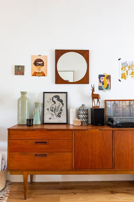 a rich-stained mid-century modern sideboard with drawers with metal handles and doors on classic cone legs is a lovely idea