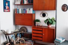 a rich stained teak wall unit with cabinets, drawers and some open shelves is a very comfy and practical unit