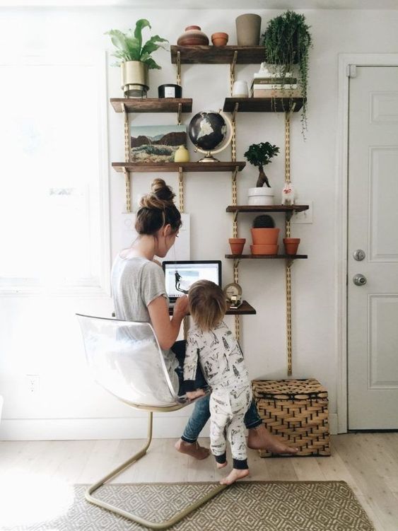 a simple and airy wall unit with open shelves and metal elements plus a desk incorporated won't take much space but will do much good