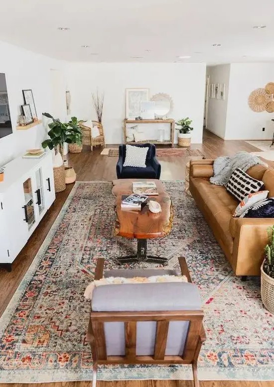 a stylish mid-century modern farmhouse living room with a leather sofa, elegant chairs, a living edge table, potted plants