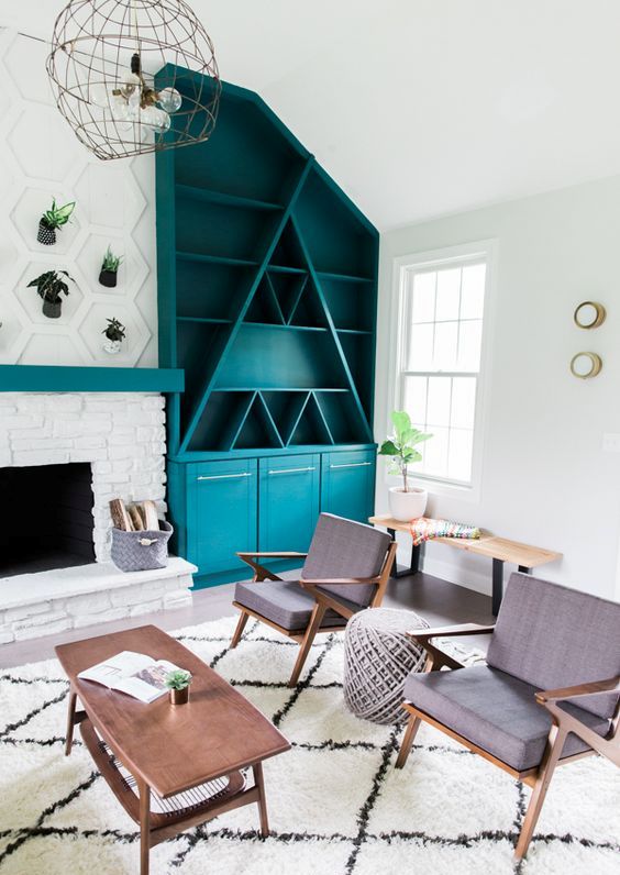 a turquoise mid-century modern bookcase with geometric elements, with open and closed storage spaces