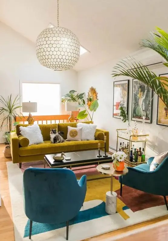 a vibrant living room in bold colors, with a mustard sofa, navy chairs, a bold abstract rug, potted plants and a cool bar cart