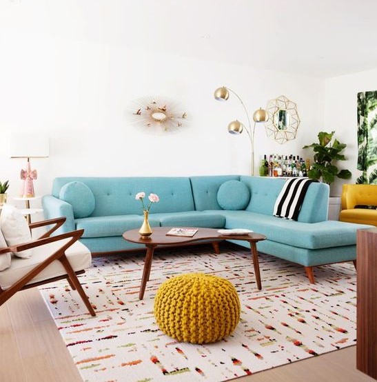 a welcoming mid-century modern living room with a modern turquoise sofa, elegant mid-century modern furniture and touches of gold for chic