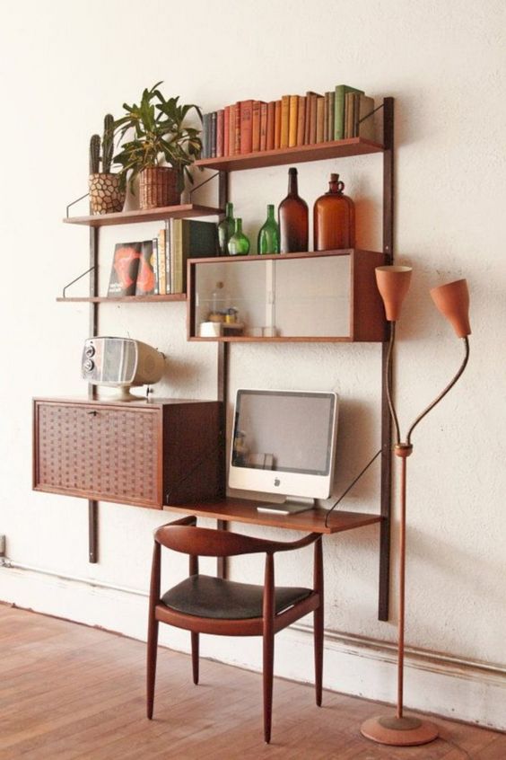 a whole mid-century modern wall-mounted system with open shelves and some cabinets plus a matching chair