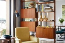 a yellow mid-century modern chair with a matching footrest and tall metal legs is a perfect mid-century modern piece