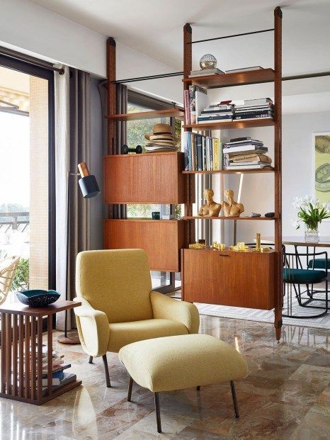 a yellow mid-century modern chair with a matching footrest and tall metal legs is a perfect mid-century modern piece