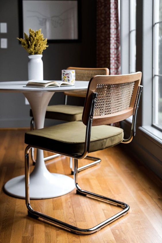 an elegant mid century modern chair of metal, an upholstered seat and a rattan back is a cool idea for a dining room