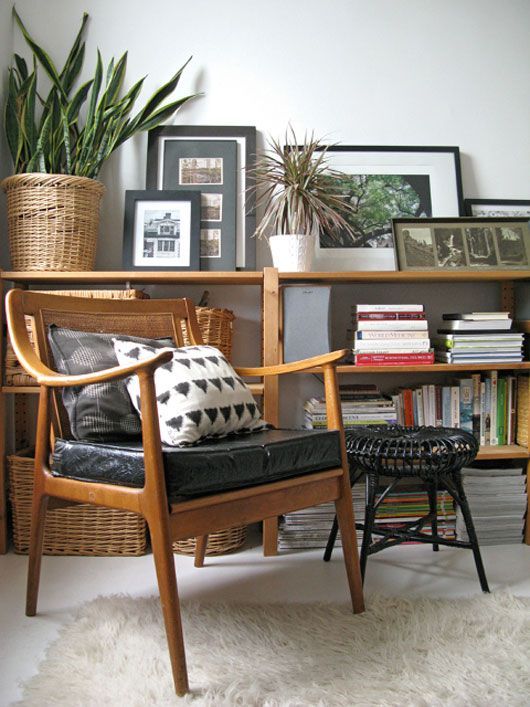 an elegant stained chair with a rattan back and a black leather seat, printed chairs is a great addition to the living room