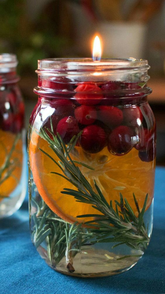 jars with rosemary, citrus slices and cranberries are great to style your space for the holidays