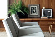 sculptural grey chairs with soft curved armrests are a catchy and bold addition to a mid-century modern living room