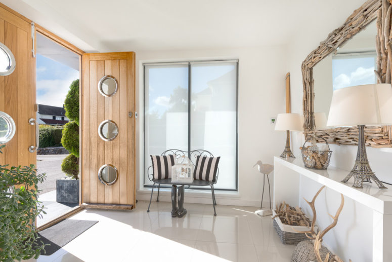 a large entryway mirror framed with driftwood for a seaside home  (Colin Cadle Photography)