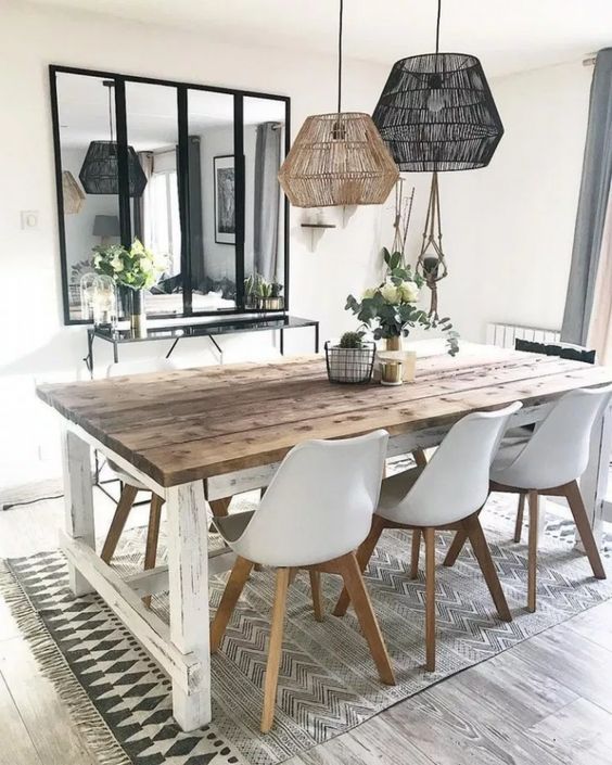 a Nordic dining room with a whitewashed table, matching chairs, matching pendant lamps and a sleek console table