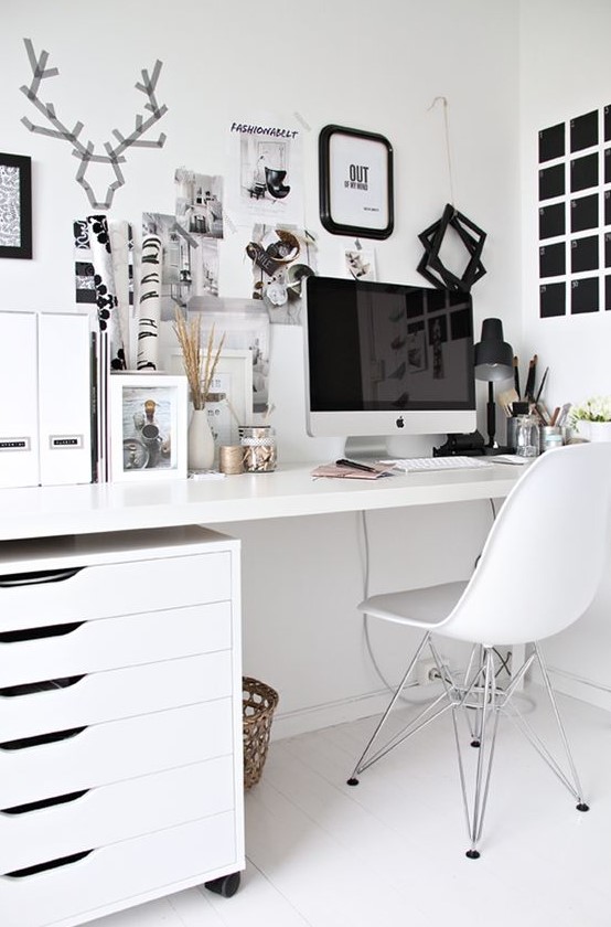 a Scandinavian home office done in mostly white, with a black noteboard and some more touches for an accent