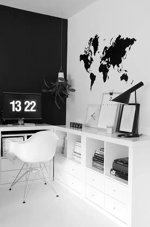 a Scandinavian home office with a black statement wall and a white one with a world map decal looks bold