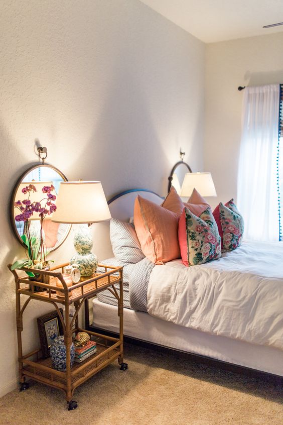 a beautiful bamboo and cane cart on casters that is usually used as a home bar, here is rocked as a nightstand with lots of storage