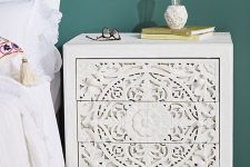 a beautiful white inlay nightstand showing off floral patterns and some other is a very refined and chic idea for a modern bedroom