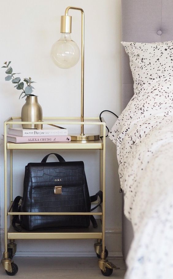 a gold tiered cart with shelves and casters is a very cool and glam idea for a bedroom, especially a girlish bedroom