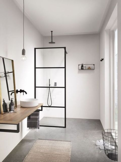 a neutral Scandi bathroom with black touches for drama, with wood and a jute rug plus a wire basket