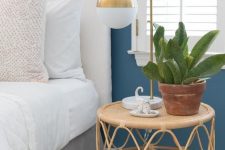 a rattan and cane small roung nightstand, a gold table lamp and a potted plant will compose a beautiful and cool combo for a bedroom