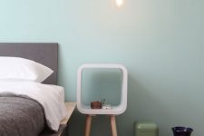 a small and pretty nightstand of a white frame with curved angles and color block legs is a lovely idea for a modern bedroom