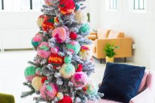 a snowy Christmas tree decorated with colorful pompoms and with colorful gifts is a very nice and bright idea