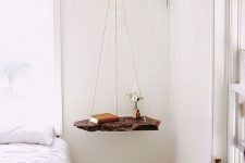 a swing nightstand of a living edge wooden piece and twine is a great way to add a lovely touch to your bedroom