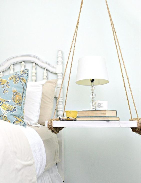 a swing nightstand of a piece of wood and twine, with a table lamp and some books will give a fun touch to your bedroom