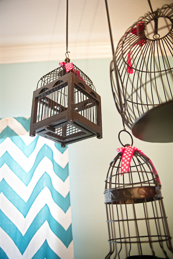 Several bird cages from a yard sale could become a cool faux chandelier. To make it cute use some awesome ribbons to hang them.