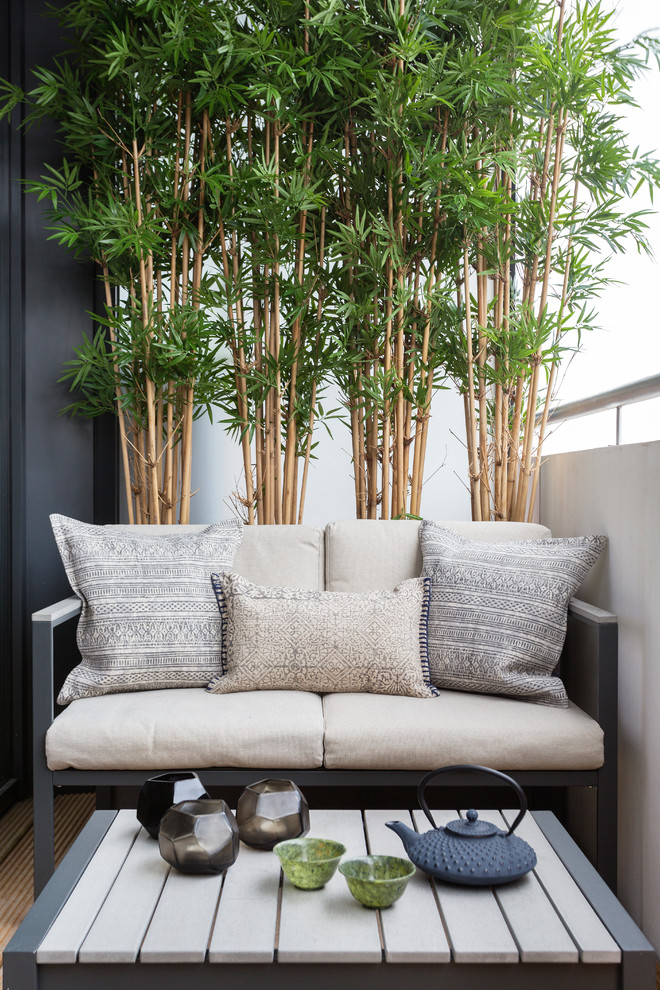 A small sofa, a coffee table and a bamboo wall would make a balcony a perfect place for an afternoon tea. (Zulufish)