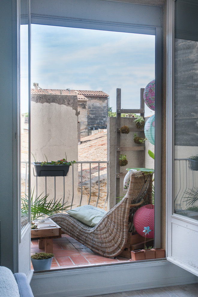 A comfy lounge chair is the best addition to a small balcony so you could relax there. Hanging planters is the best way to add some greenery there without occupying much space. (Jours &amp; Nuits)