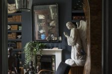 a Gothic living room with a tiled fireplace, molding, black furniure, unique artworks and greenery in pots