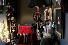 a Gothic living room with black walls, a refined red chair, skulls and a chic gallery wall is striking