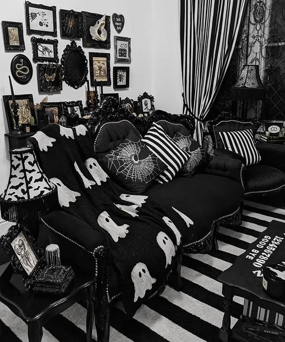 a fun Gothic living room done in black and white, with refined furniture, printed pillows, a catchy gallery wall and textiles