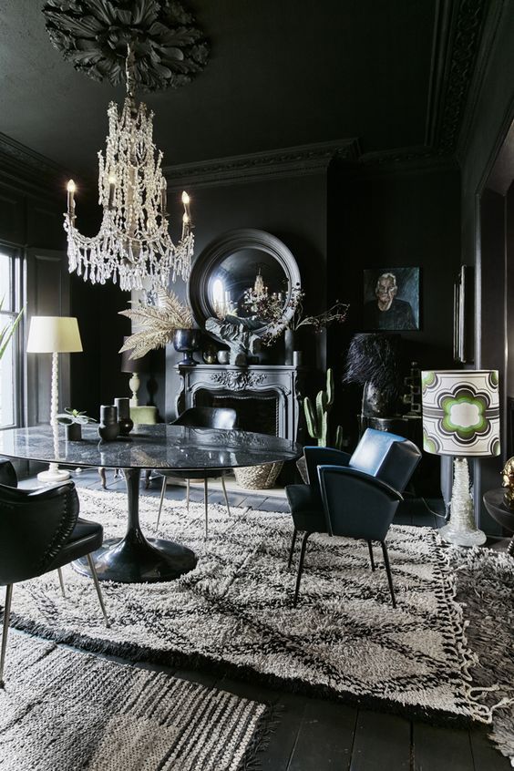 https://www.digsdigs.com/photos/2014/02/a-modern-Gothic-dining-room-with-black-walls-floos-and-a-ceiling-a-stone-table-leather-chairs-mirrors-artworks-and-a-refined-chandelier.jpg