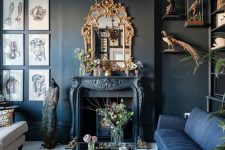 a modern Gothic living room with black walls, ablue and white sofa, a fireplace, a refined chandelier and mirror, catchy artworks