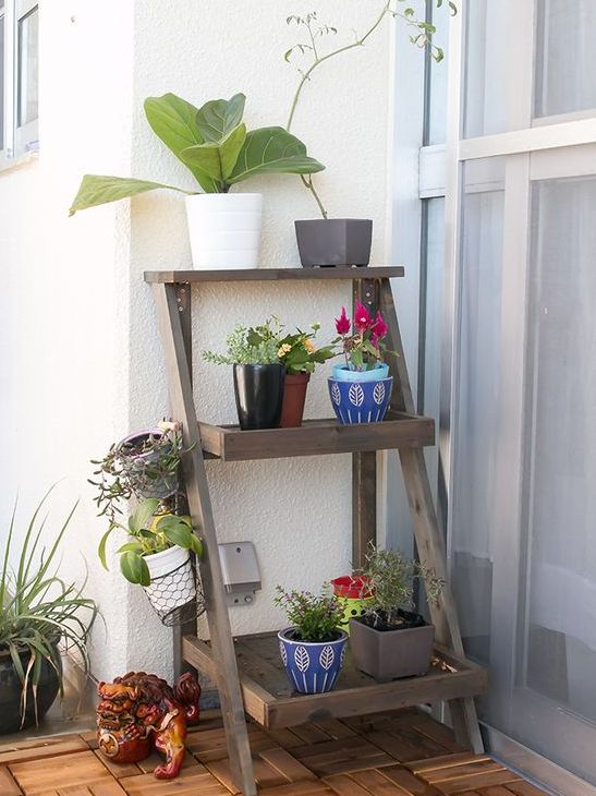 a simple foldable piece of furniture features three shelves for all the stuff you need