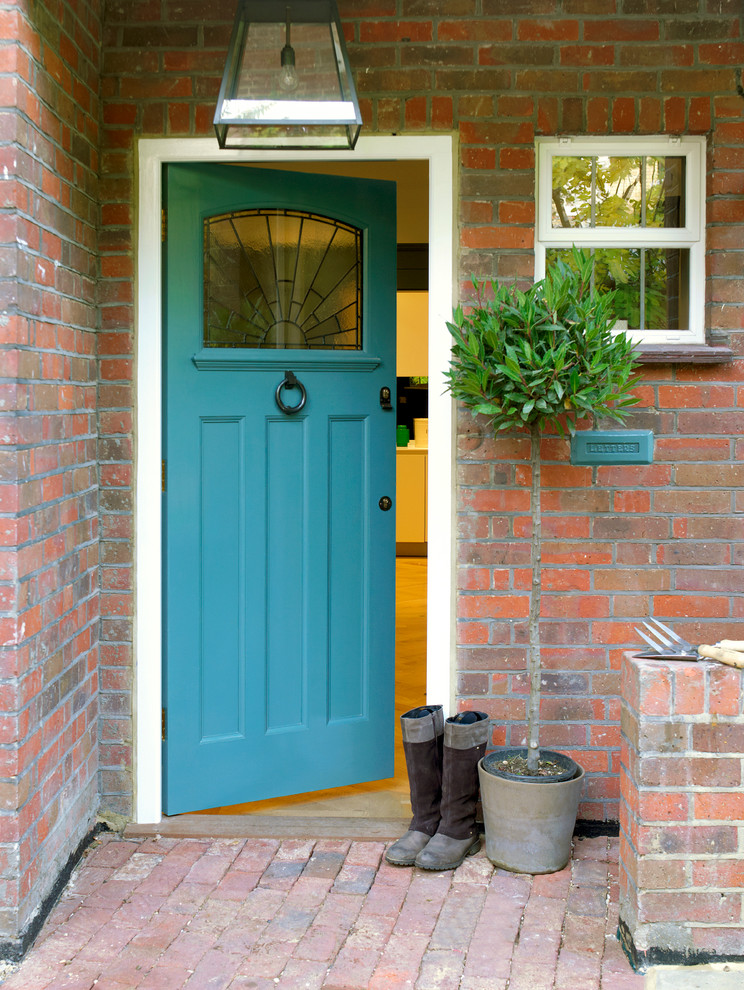 blue is a great color for a front door in a brick house  (Hannah Brown)