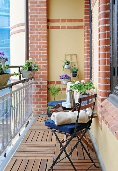 potted greenery and blooms and some usual garden chairs with cushions are nice for a spring outdoor space