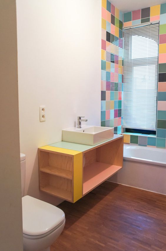 a contemporary bathroom with bold tiles around the tub, a floating storage vanity with colorful touches is amazing and fresh