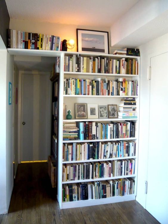 a corner all covered with bookshelf built-ins is a stylish way to use your awkward nook and store some books