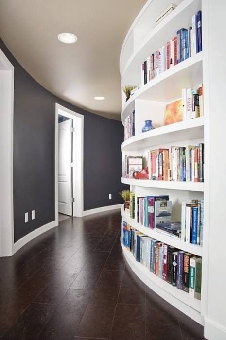 a curved wall with built-in bookshelves will save a lot of space you may need for books and will make use of the wall