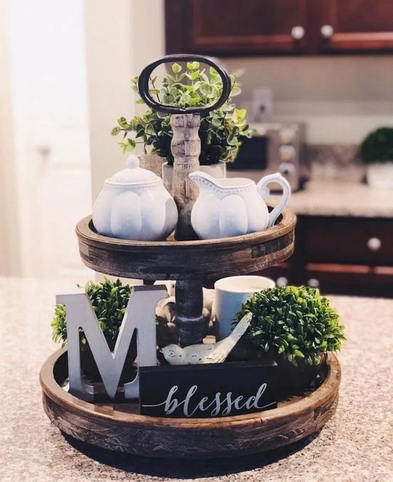 a farmhouse kitchen stand with greenery, letters, an artwork, porcelain and mugs for spring