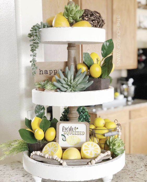 a farmhouse spring kitchen with succulents, fake lemons and greenery, an artwork, beads and a vine ball