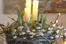 a faux nest with willow, whitewashed pinecones, moss, bulbs and candles is a cool decoration or centerpiece