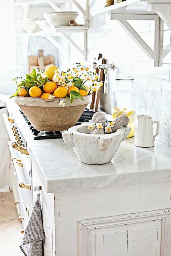 a large bowl with lemons and white blooms is a bold and cool idea for spring kitchen decor